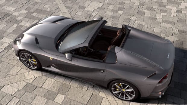 A sleek gray Ferrari 812 Gts convertible is parked on stone pavement, 4K Desktop Wallpaper
