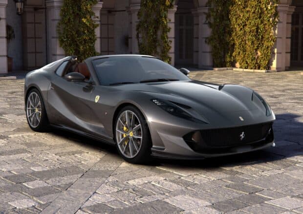 A gray Ferrari 812 Gts is parked on cobblestone with ivy on columns behind, HD Desktop Wallpaper
