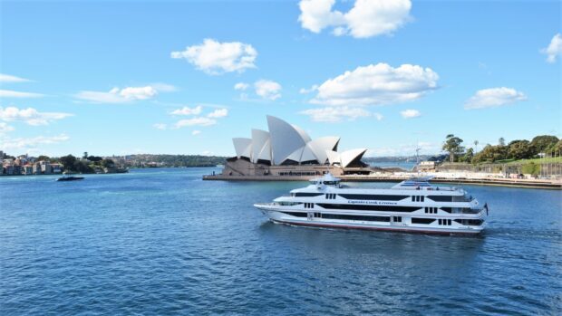 A ferry cruises smoothly past the Sydney Opera House under a bright blue sky, HD Desktop Wallpaper
