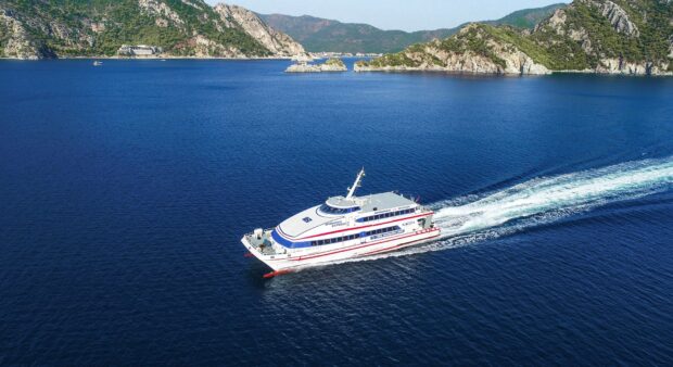 A ferry sailing across the deep blue sea with rocky islands in the background, HD Desktop Wallpaper