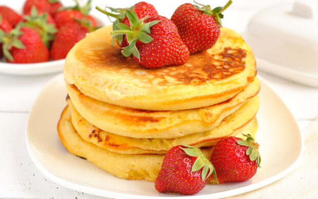 A stack of fluffy pancakes topped with fresh strawberries on a white plate, HD Desktop Wallpaper