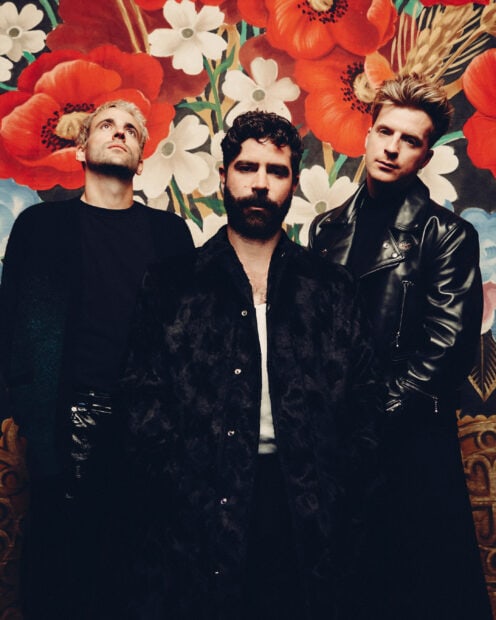 The Foals band stands against a colorful floral mural showcasing their artistic style, 2K PC Wallpaper