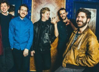 Foals band members pose casually in a vibrant indoor setting, HD Desktop Wallpaper