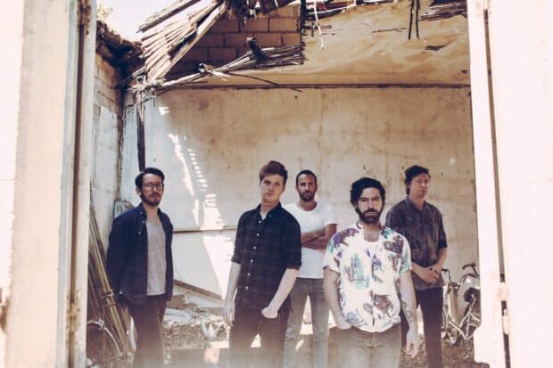 The Foals band members stand inside a partially ruined building, Foals Band HD Desktop Wallpaper