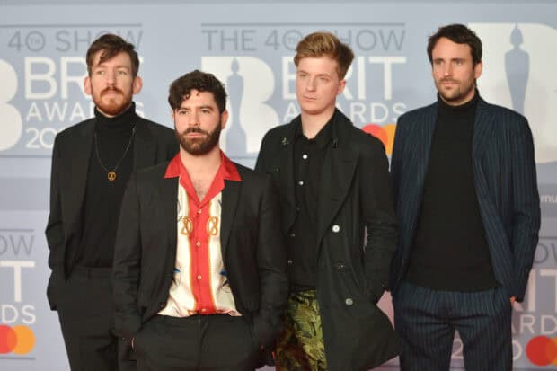 Foals Band members posing at the BRIT Awards show in formal attire, 2K Desktop Wallpaper