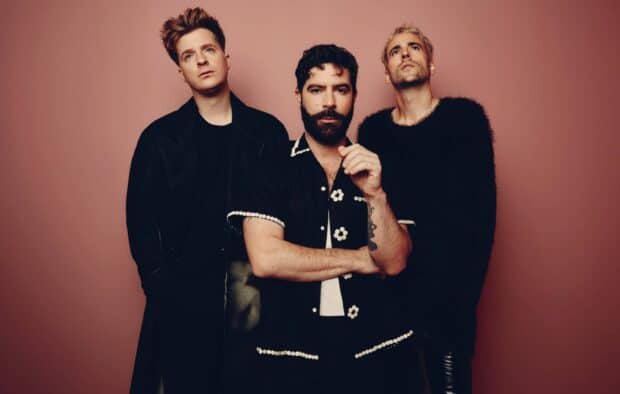 The Foals band members pose together wearing dark outfits and serious expressions, HD Desktop Wallpaper