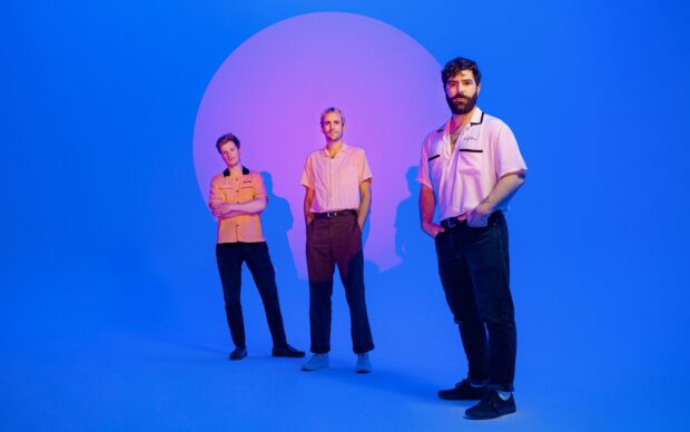 The Foals band stands together with a blue and purple color backdrop, Foals Band Wallpapers, HD Desktop Wallpaper