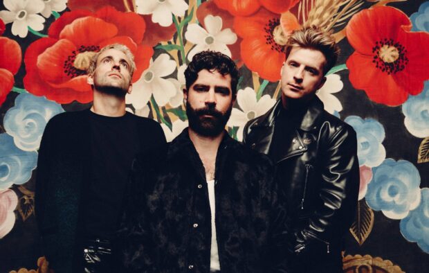 The Foals band stands before a colorful flower backdrop with intense expressions, HD Desktop Wallpaper