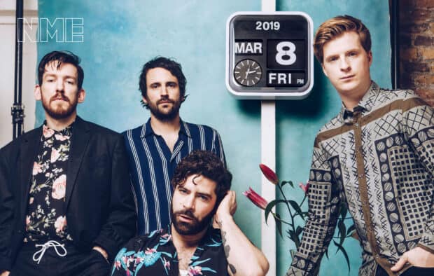 The Foals band members pose in a studio setting with a calendar showing March 8 2019, HD Desktop Wallpaper