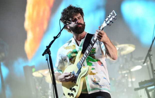A Foals band guitarist passionately plays guitar on stage during a concert, HD Desktop Wallpaper