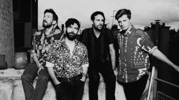 The Foals band members pose outdoors in a black and white photo, 2K Desktop Wallpaper