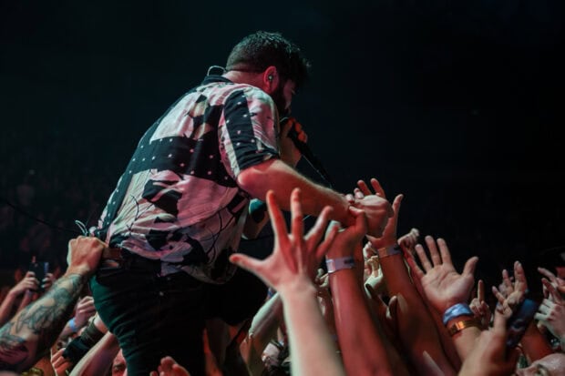 A Foals band member reaches out to fans during a live concert, HD Desktop Wallpaper