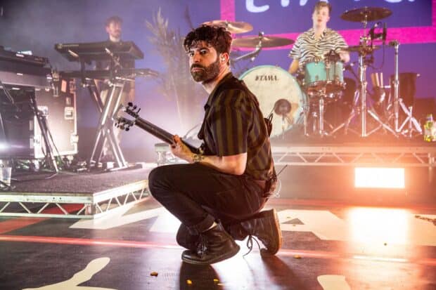 A member of Foals band plays guitar on stage during a live performance, 2K Desktop Wallpaper