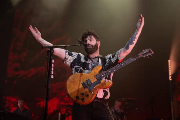 A Foals band member sings and plays guitar during a concert, HD Desktop Wallpaper