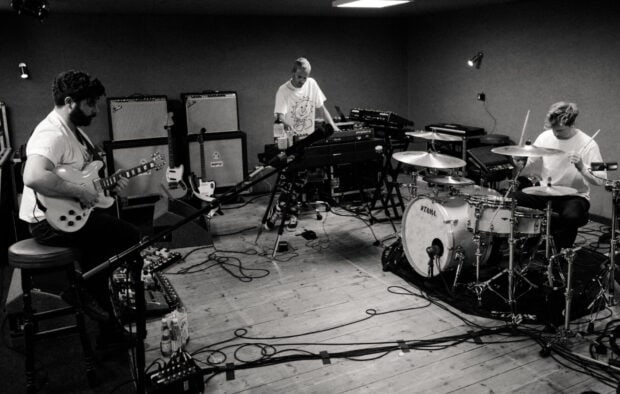 Foals band playing instruments together in a music studio room, HD Desktop Wallpaper
