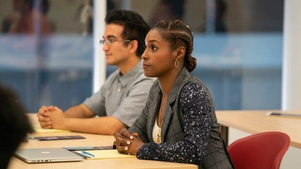 A woman attentively listens during a meeting in Insecure Tv Series, HD Desktop Wallpaper