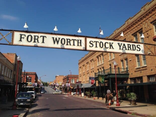 A clear day in Fort Worth Stock Yards with historic buildings and people on the street, HD Desktop Wallpaper