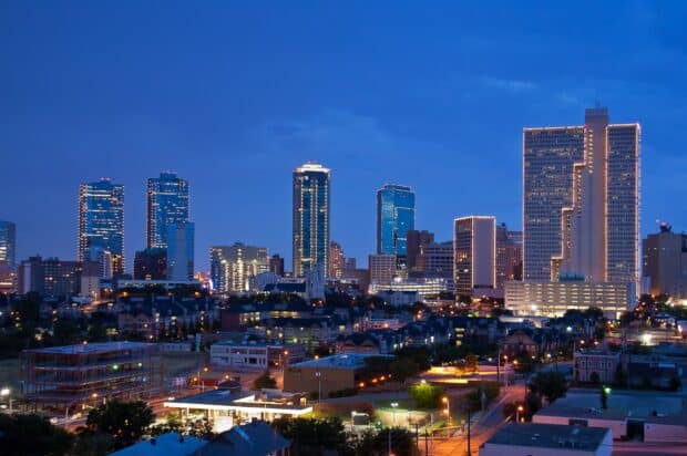 The Fort Worth skyline is beautifully lit during dusk with vibrant lights and buildings, 2K Desktop Wallpaper