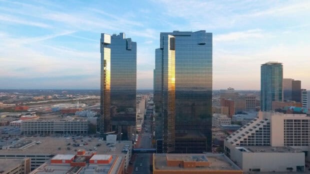 The Fort Worth city skyline shows reflective glass buildings during sunset in this urban view, HD Desktop Wallpaper
