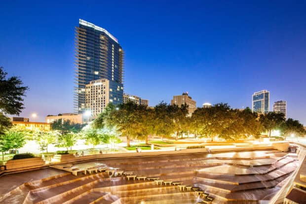 The Fort Worth skyline glows as the sun sets with a clear evening sky, 2K Desktop Wallpaper