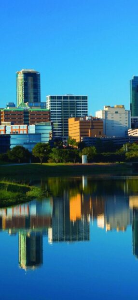 The Fort Worth skyline reflects beautifully in the calm water under a clear blue sky, HD Mobile Wallpaper