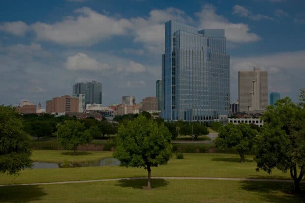 A clear view of Fort Worth skyline with trees and buildings under a blue sky, HD Desktop Wallpaper