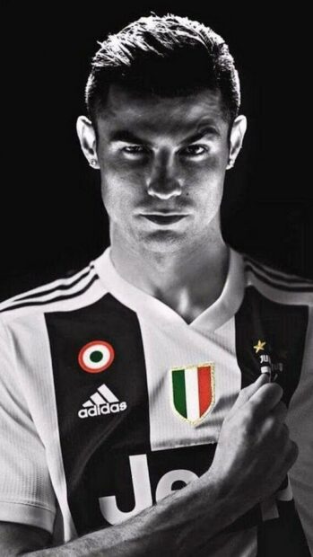A confident football player wears the Juventus jersey showing team pride, HD Mobile Wallpaper
