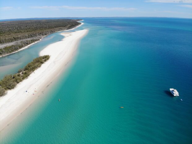 Aerial view of Fraser Island with clear blue waters and white sandy beaches, 2K Desktop Wallpaper