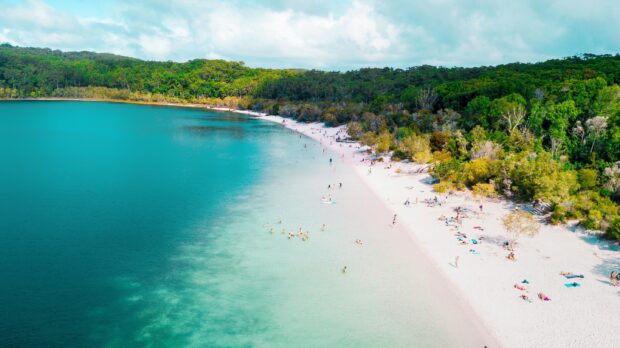 People enjoying the clear water at Fraser Island shore, 2K Desktop Wallpaper
