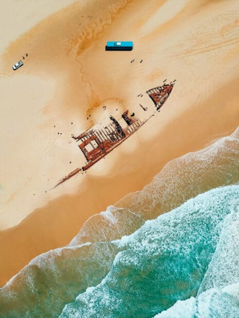 Aerial view of Fraser Island shipwreck with sandy beach and waves, HD Desktop Wallpaper