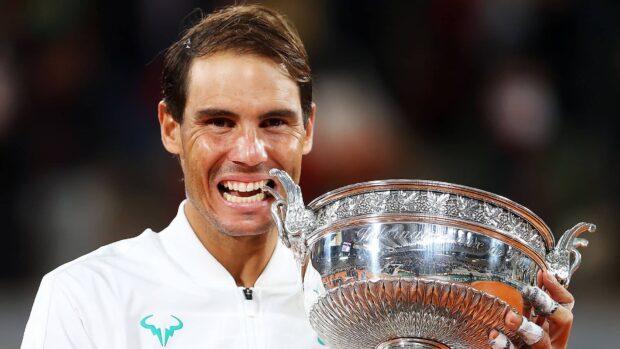 A tennis player bites the Roland Garros trophy after winning the French Open Roland Garros title, HD Desktop Wallpaper