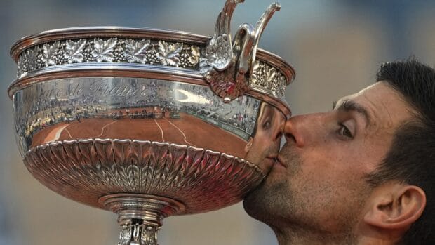 A tennis player kisses the French Open Roland Garros trophy after winning, HD Desktop Wallpaper