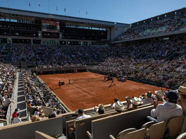 A tennis match is taking place on the clay court at the French Open Roland Garros with a full crowd, HD Desktop Wallpaper