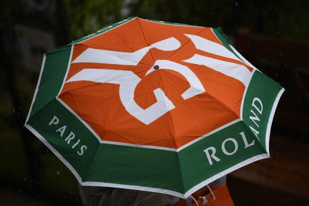 A close up view of an umbrella with the French Open Roland Garros logo protecting from rain, HD Desktop Wallpaper