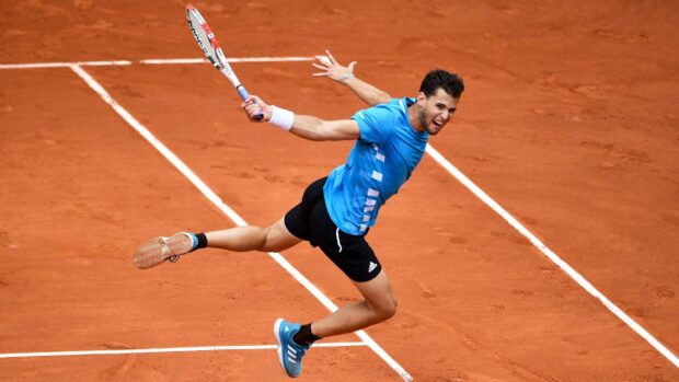 A tennis player is jumping to hit a ball on the clay court at the French Open Roland Garros, HD Desktop Wallpaper