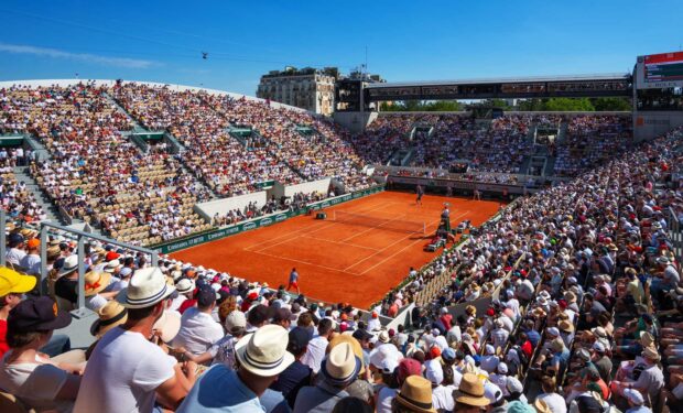 A large crowd watches an intense French Open Roland Garros tennis match on a sunny day, HD Desktop Wallpaper