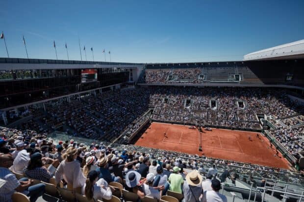 A wide view of the French Open Roland Garros clay court filled with players and spectators, 2K Desktop Wallpaper