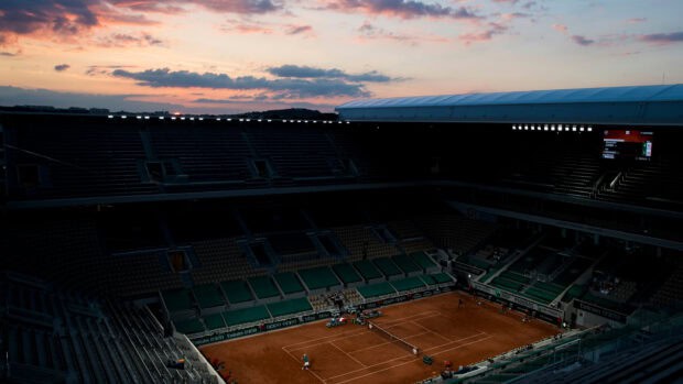 A tennis match is taking place at French Open Roland Garros with a sunset sky above the stadium, 2K Desktop Wallpaper