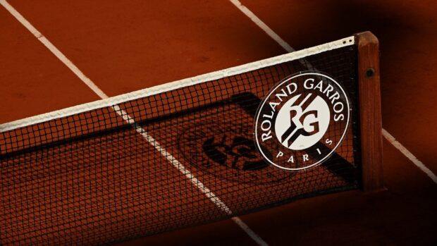 A close up of the Roland Garros logo on a tennis net with a clay court in the background, HD Desktop Wallpaper