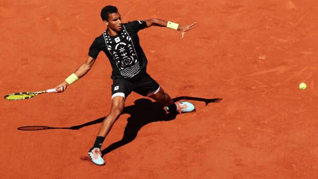 A tennis player competes on the clay court during the French Open Roland Garros tournament, HD Desktop Wallpaper