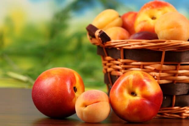Ripe apricot wallpapers, Fresh apricot fruits arranged beside a wicker basket on a wooden surface, ripe apricot wallpapers, 2K Desktop Wallpaper