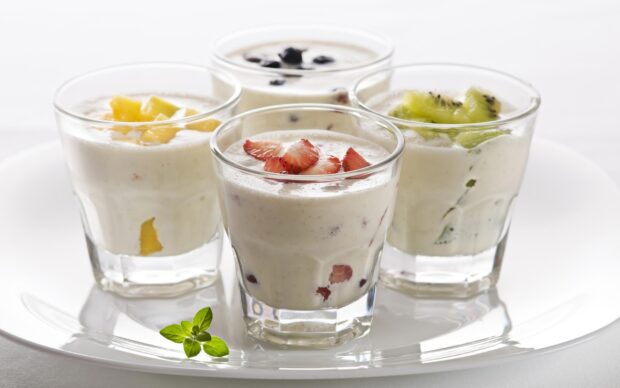 A glass of fresh milkshake with strawberries and kiwi on a white plate, 2K Desktop Wallpaper
