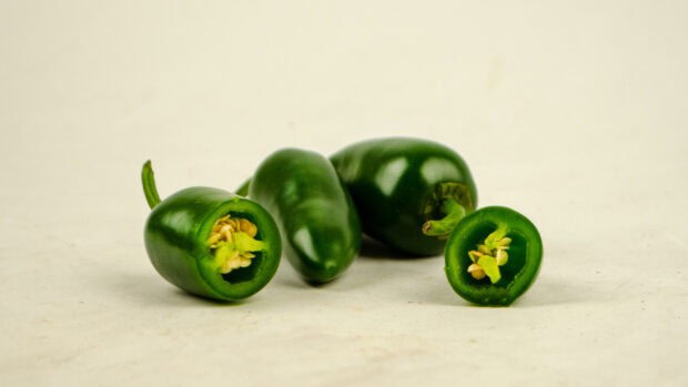 Two jalapeno peppers are cut open showing seeds inside, HD Desktop Wallpaper
