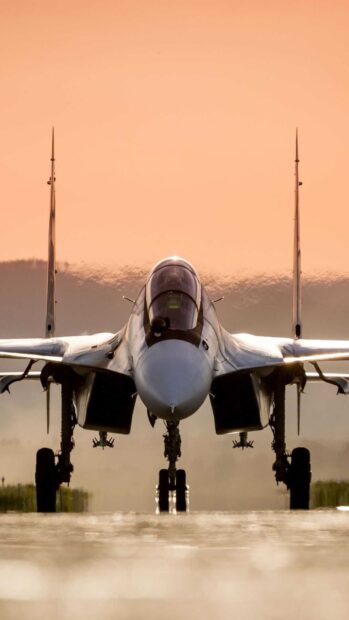 A jet fighter is positioned on the runway with a glowing sunset sky in the background, HD Mobile Wallpaper