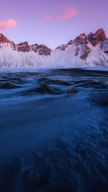 A frozen mountain landscape with purple sky and glacier snow, 4K Phone Wallpaper