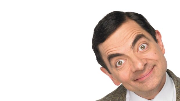 Rowan Atkinson shows a playful expression with wide eyes and a tilted head, HD Desktop Wallpaper
