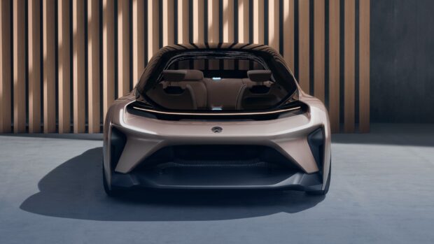 A sleek Nio auto is parked in front of wooden panels, HD Desktop Wallpaper