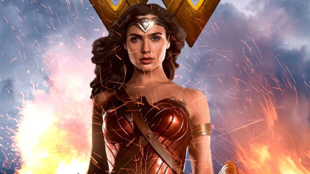 Gal Gadot as Wonder Woman stands confidently with sparks flying around her, 2K Desktop Wallpaper
