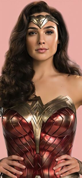 Gal Gadot as Wonder Woman stands confidently in her armor with a pink background, HD Phone Wallpaper