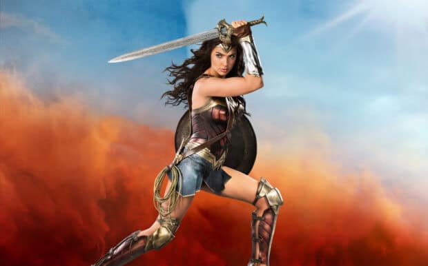 Gal Gadot as Wonder Woman stands ready with sword and shield against a stormy sky, HD Desktop Wallpaper